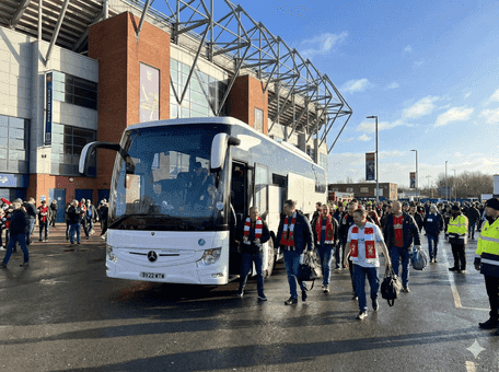 Coach arriving at a sports stadium on match day