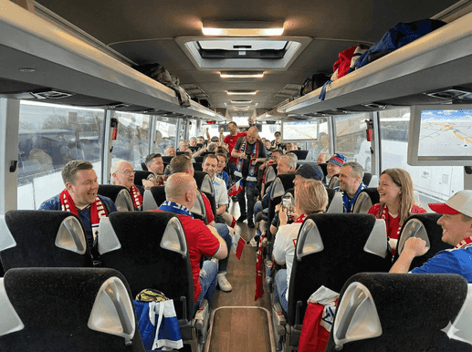 Sports fans enjoying travel on modern coach