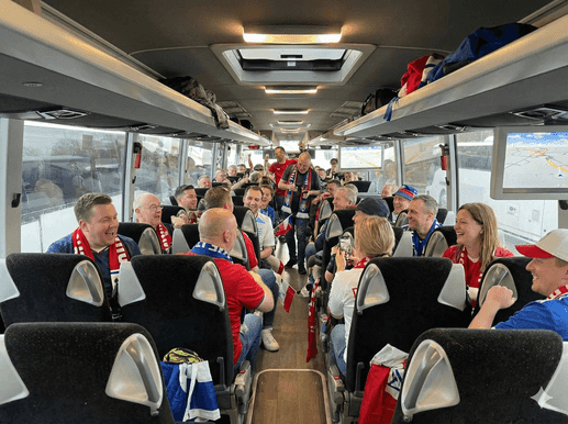 Sports fans enjoying travel on modern coach